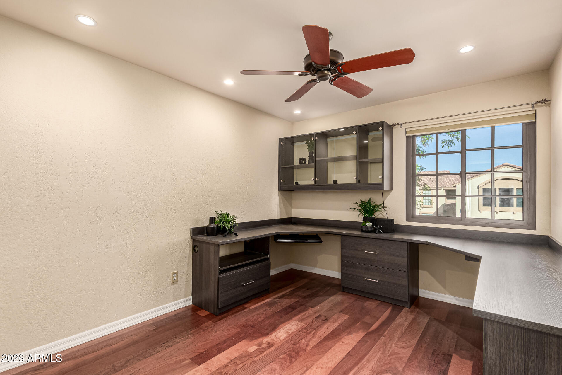 4279 East Agave Road Phoenix, AZ 85044 - Photo 23 of 31 a kitchen with granite countertop a sink cabinets wooden floor and stainless steel appliances