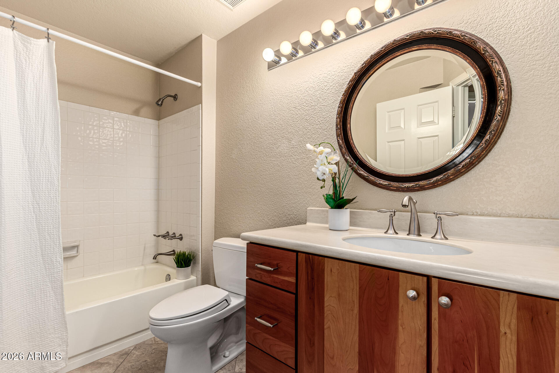 4279 East Agave Road Phoenix, AZ 85044 - Photo 24 of 31 a bathroom with a sink and a mirror