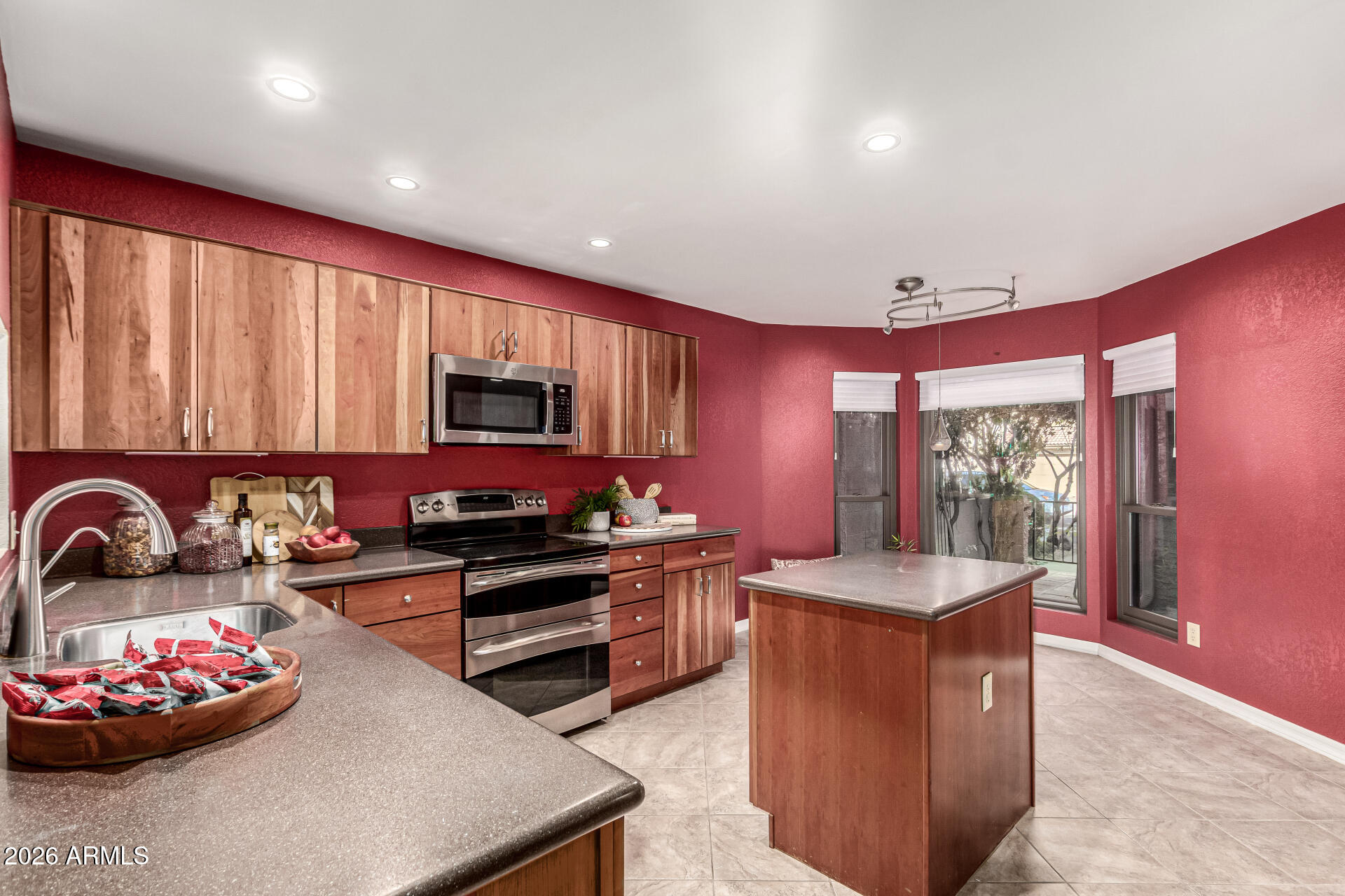 4279 East Agave Road Phoenix, AZ 85044 - Photo 6 of 31 a kitchen with sink a stove and a microwave