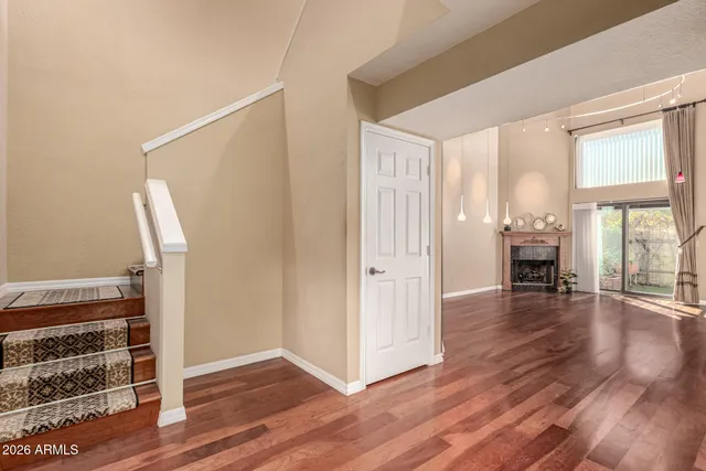 a view of a living room with wooden floor and ceiling fan