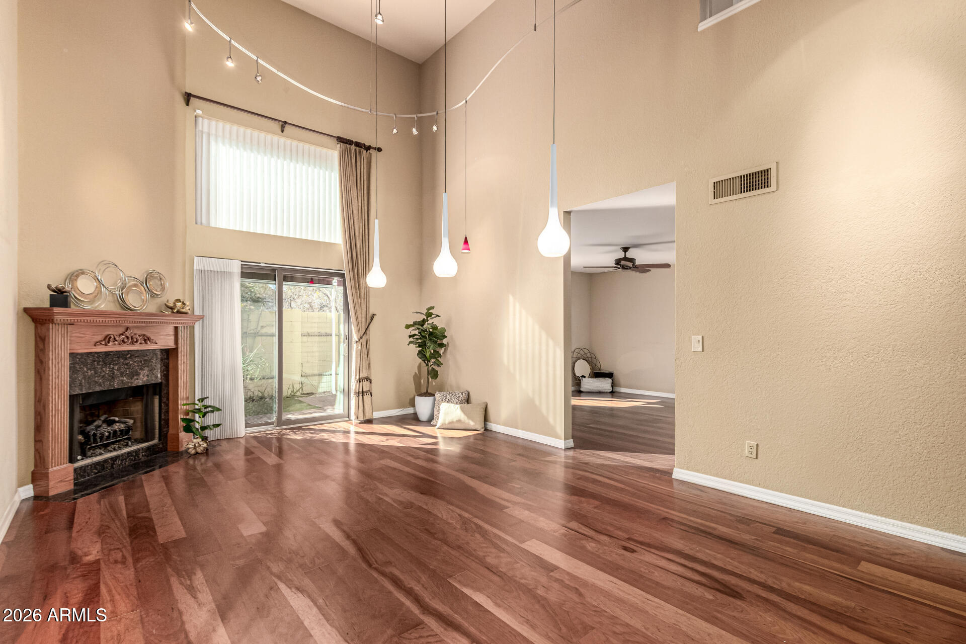 4279 East Agave Road Phoenix, AZ 85044 - Photo 10 of 31 a hallway with a fireplace and wooden floor