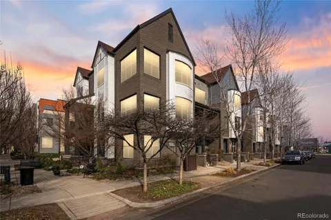 a front view of a building with trees
