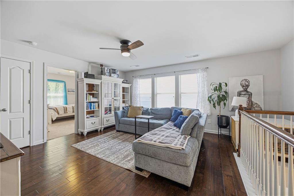 4021 Princeton Lakes Pass Southwest Atlanta, GA 30331 - Photo 11 of 23 a living room with furniture and a wooden floor