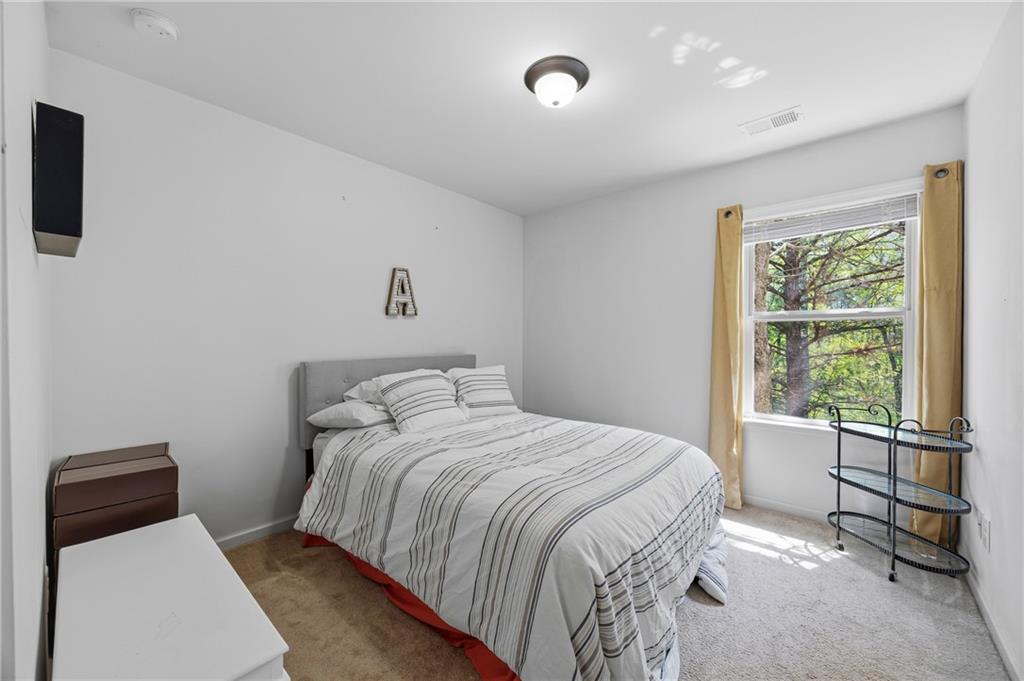 4021 Princeton Lakes Pass Southwest Atlanta, GA 30331 - Photo 14 of 23 a bedroom with a bed and a window