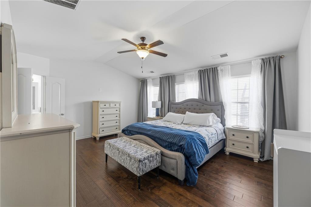 4021 Princeton Lakes Pass Southwest Atlanta, GA 30331 - Photo 16 of 23 a bedroom with a bed and a chandelier