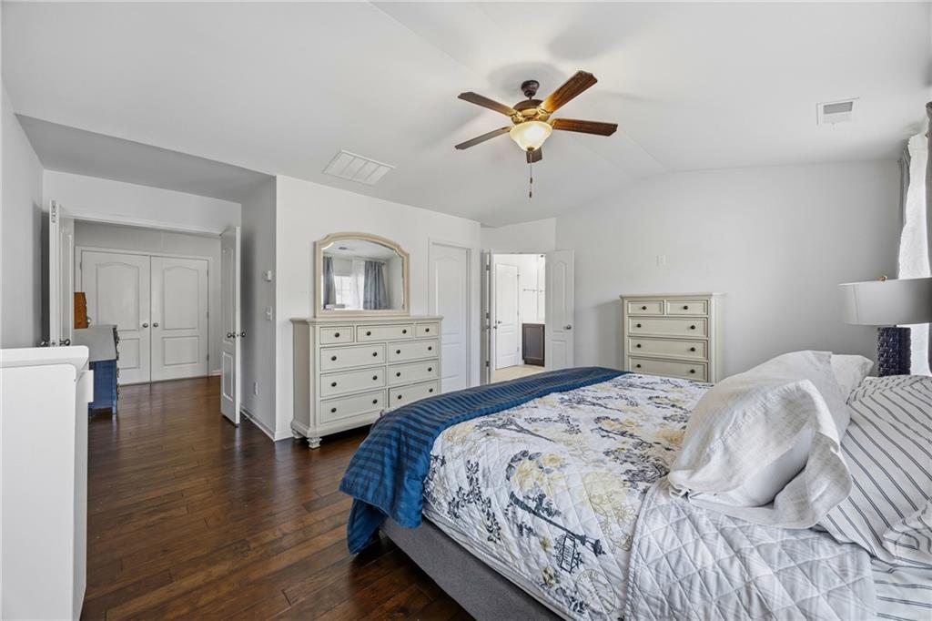 4021 Princeton Lakes Pass Southwest Atlanta, GA 30331 - Photo 17 of 23 a bedroom with a bed and a chandelier