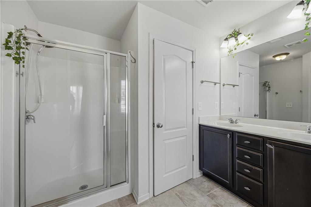 4021 Princeton Lakes Pass Southwest Atlanta, GA 30331 - Photo 18 of 23 a spacious bathroom with a double vanity sink mirror and shower