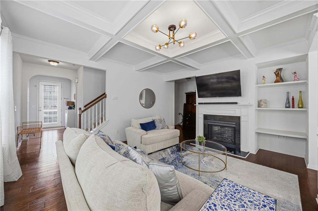4021 Princeton Lakes Pass Southwest Atlanta, GA 30331 - Photo 5 of 23 a living room with furniture a fireplace and a flat screen tv