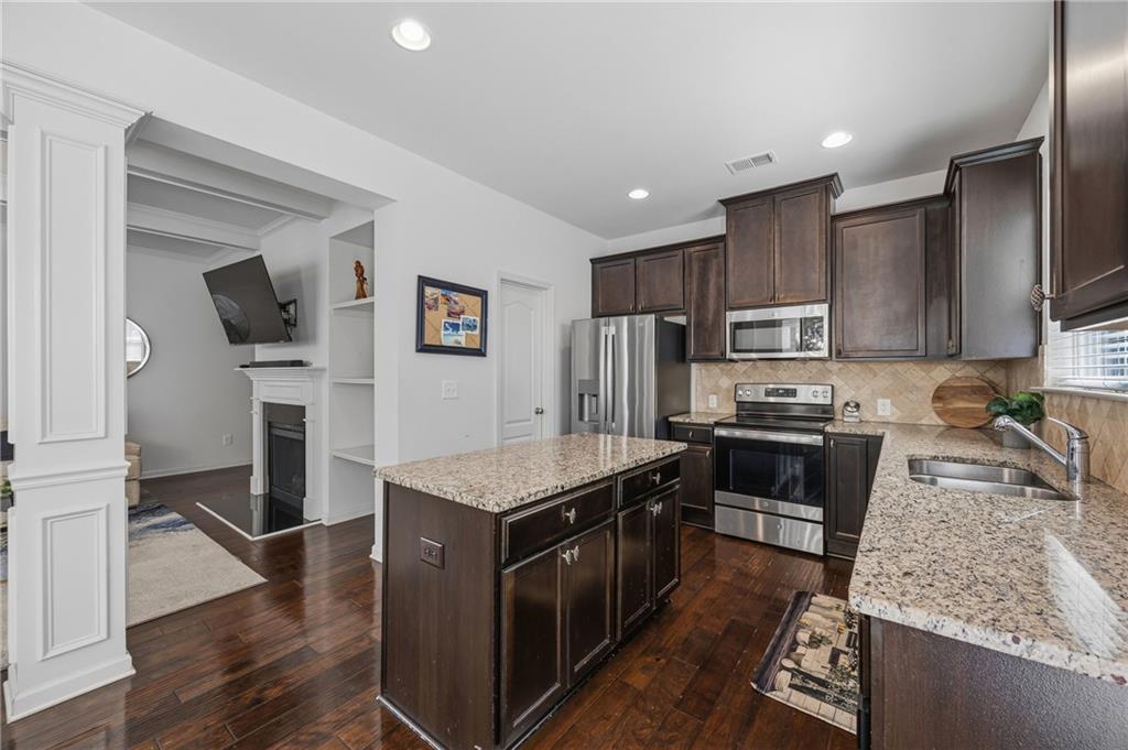 4021 Princeton Lakes Pass Southwest Atlanta, GA 30331 - Photo 8 of 23 a kitchen with kitchen island granite countertop stainless steel appliances a stove refrigerator sink and microwave