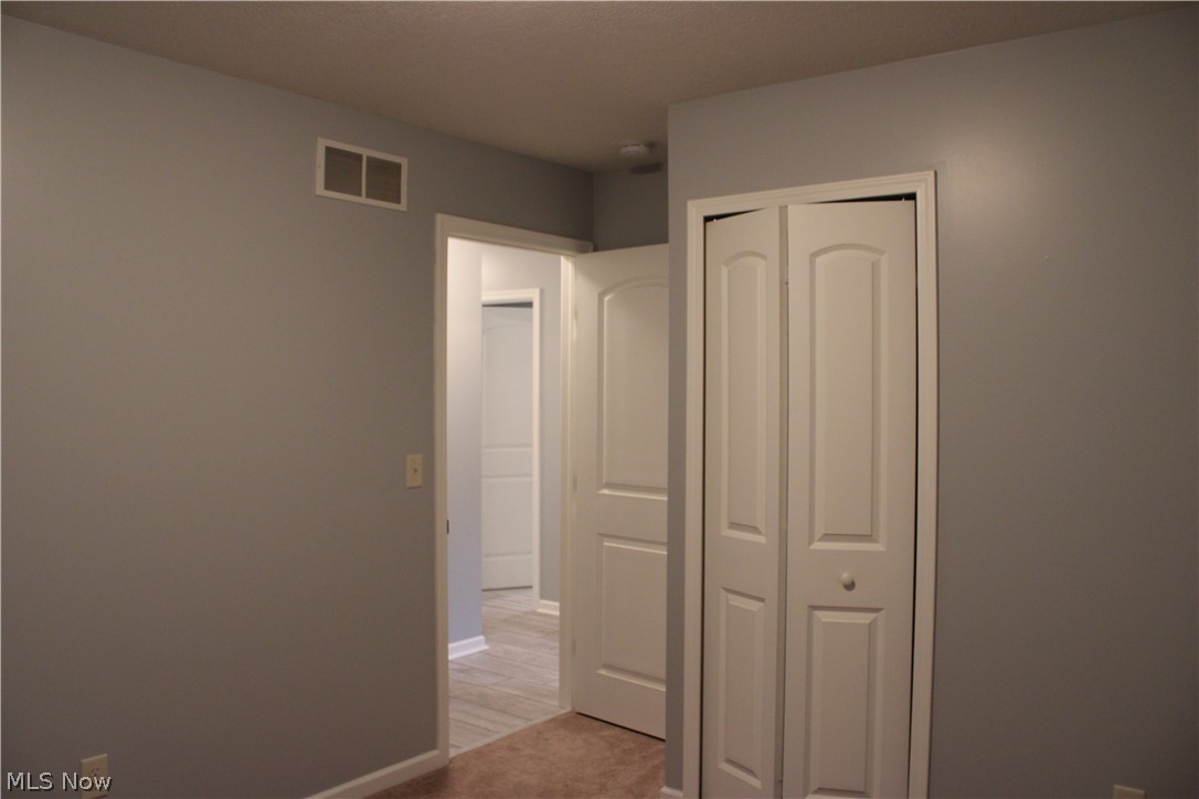 202 Home Street Rittman, OH 44270 - Photo 40 of 47 Neutral wall color, bi-fold closet doors, white interior doors, and carpet flooring