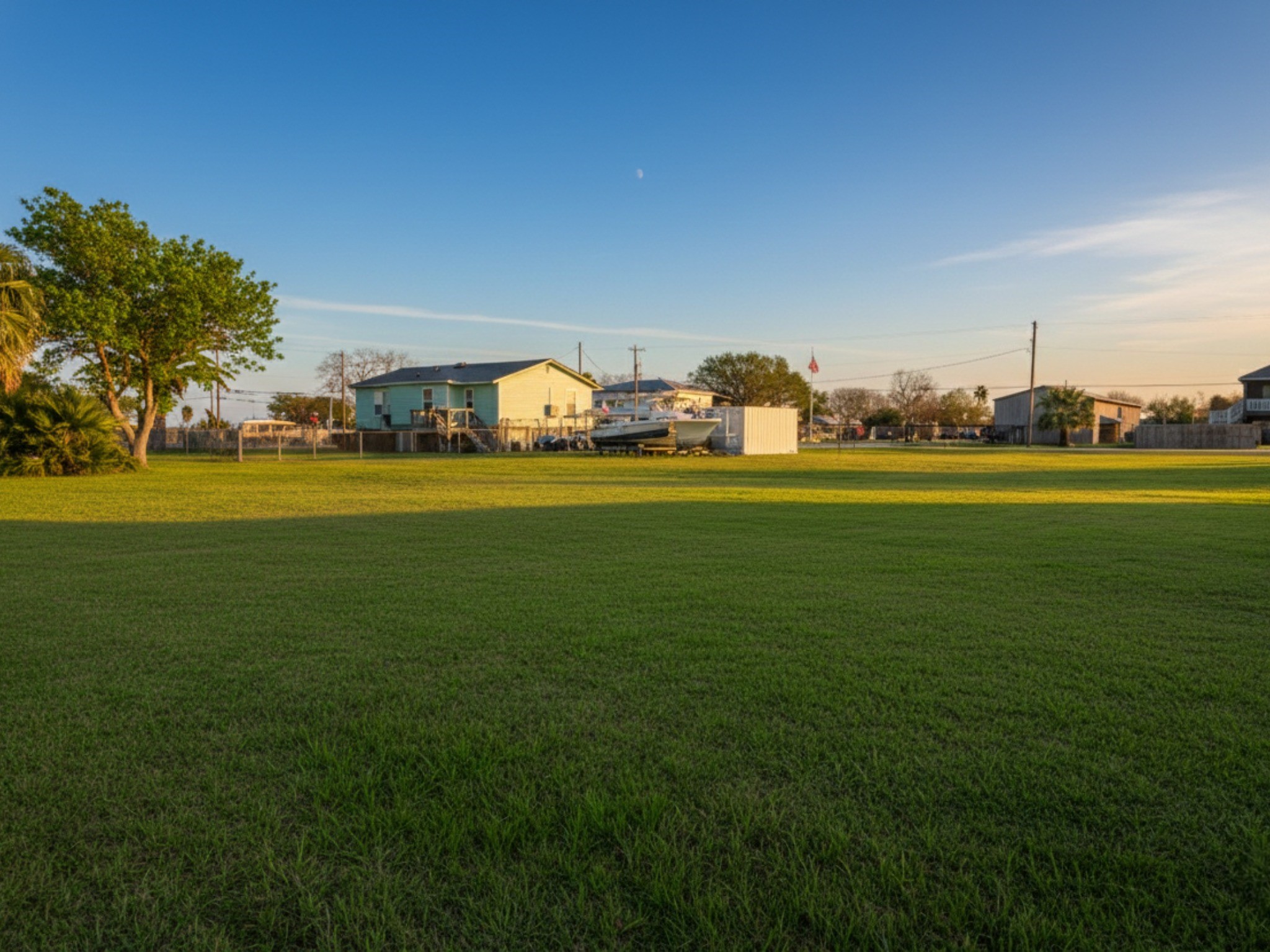 230 22nd Street Dickinson, TX 77539 - Photo 10 of 15 Golden hour shot looking across the lush green acreage.