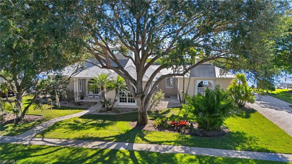 132 Wilderness Cay Naples, FL 34114 - Photo 1 of 24 a view of a house with swimming pool and garden