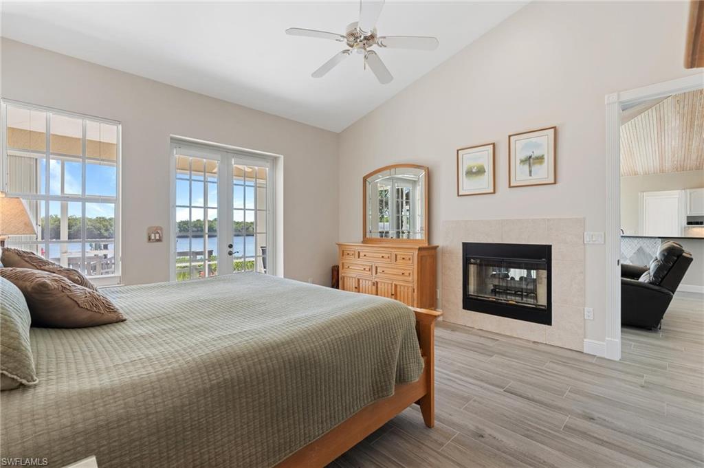 132 Wilderness Cay Naples, FL 34114 - Photo 12 of 24 a bedroom with a bed and a fireplace