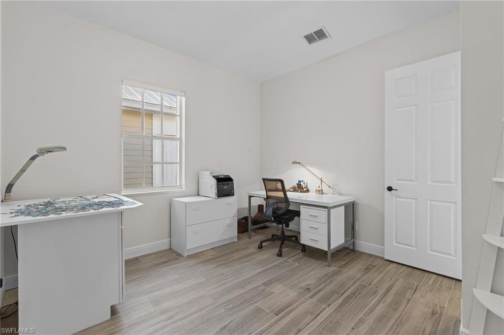 132 Wilderness Cay Naples, FL 34114 - Photo 15 of 24 a workspace with wooden floor