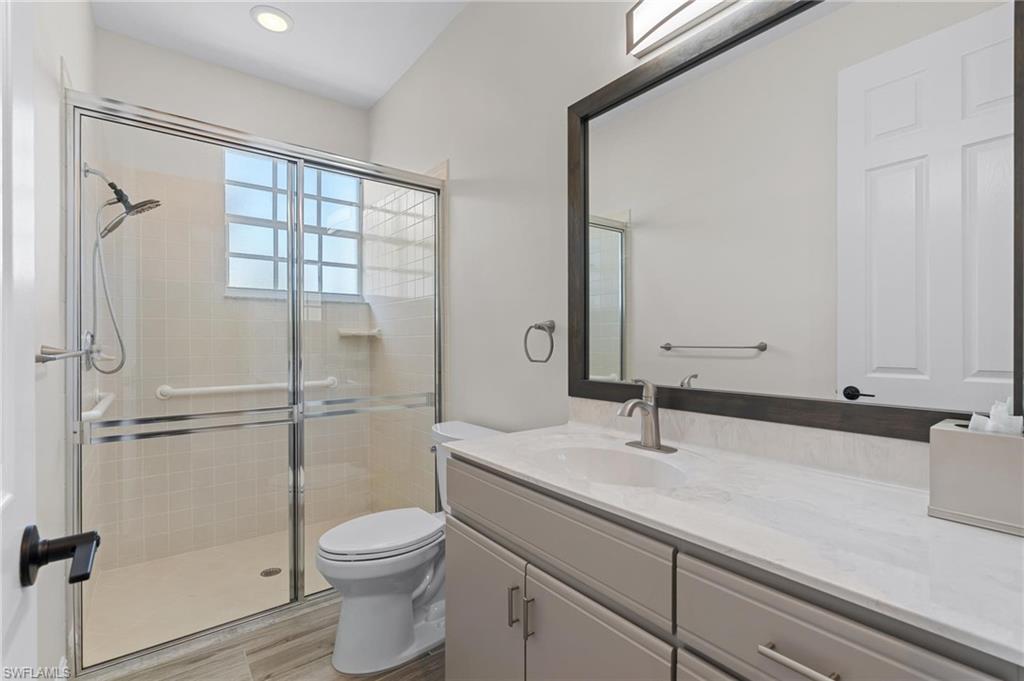132 Wilderness Cay Naples, FL 34114 - Photo 17 of 24 a bathroom with a sink a toilet and shower