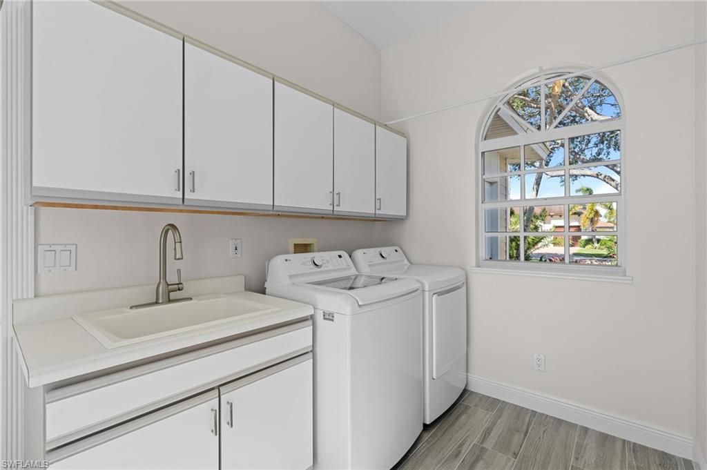 132 Wilderness Cay Naples, FL 34114 - Photo 18 of 24 a utility room with dryer and washer
