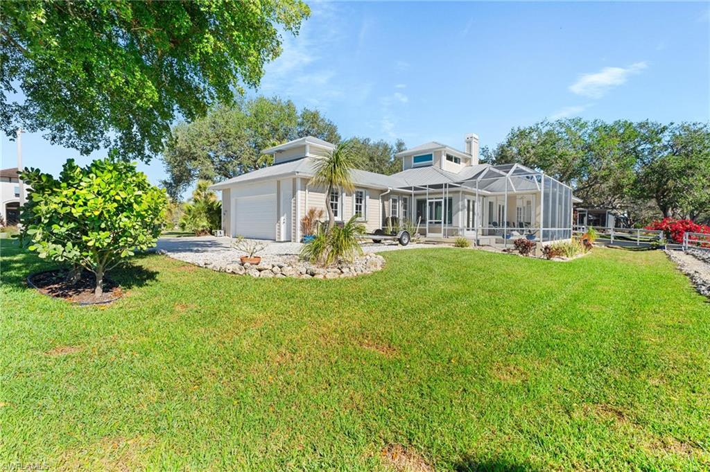 132 Wilderness Cay Naples, FL 34114 - Photo 20 of 24 a front view of a house with garden