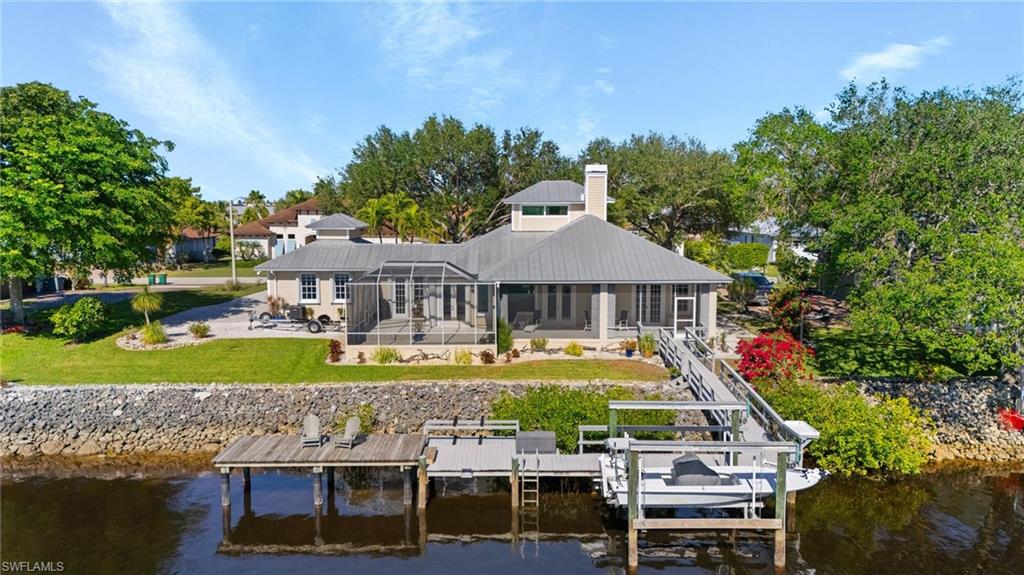 132 Wilderness Cay Naples, FL 34114 - Photo 21 of 24 a aerial view of a house with a yard table and chairs