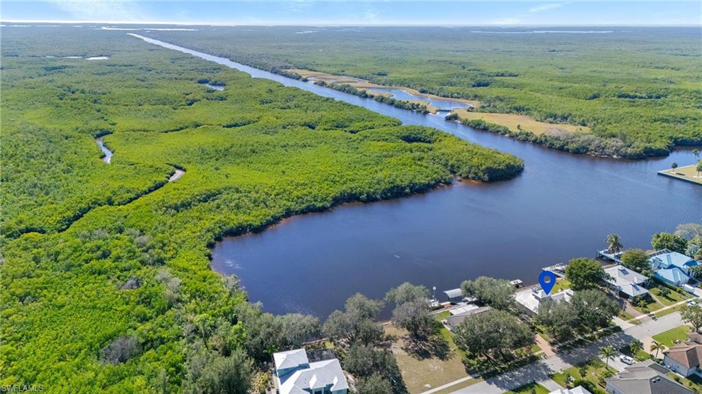 132 Wilderness Cay Naples, FL 34114 - Photo 4 of 24 a view of a lake with a yard