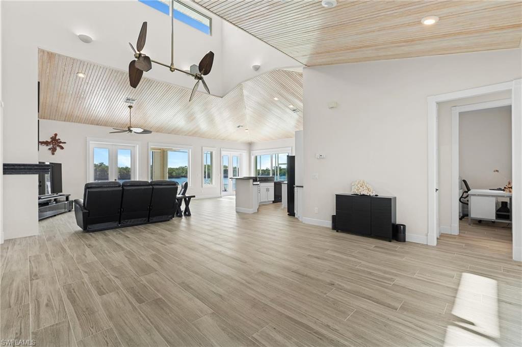 132 Wilderness Cay Naples, FL 34114 - Photo 7 of 24 a living room with furniture and wooden floor