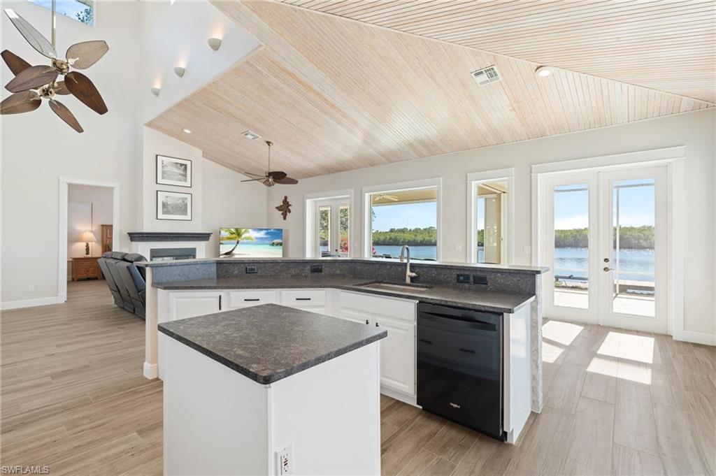 132 Wilderness Cay Naples, FL 34114 - Photo 9 of 24 a kitchen with a stove a counter space and wooden floor