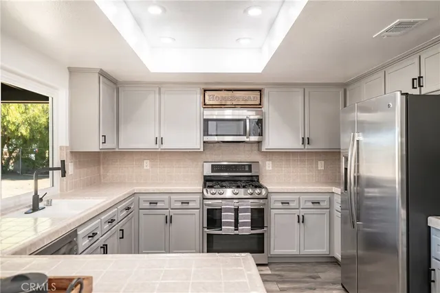 a kitchen with a sink stove and refrigerator