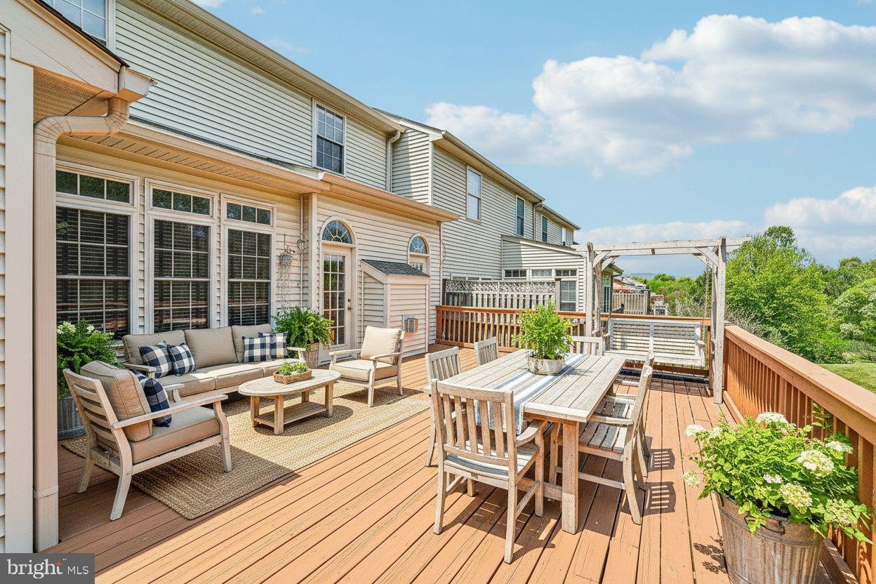 2422 Rippling Brook Road Frederick, MD 21701 - Photo 32 of 35 a view of a patio with couches table and chairs and potted plants