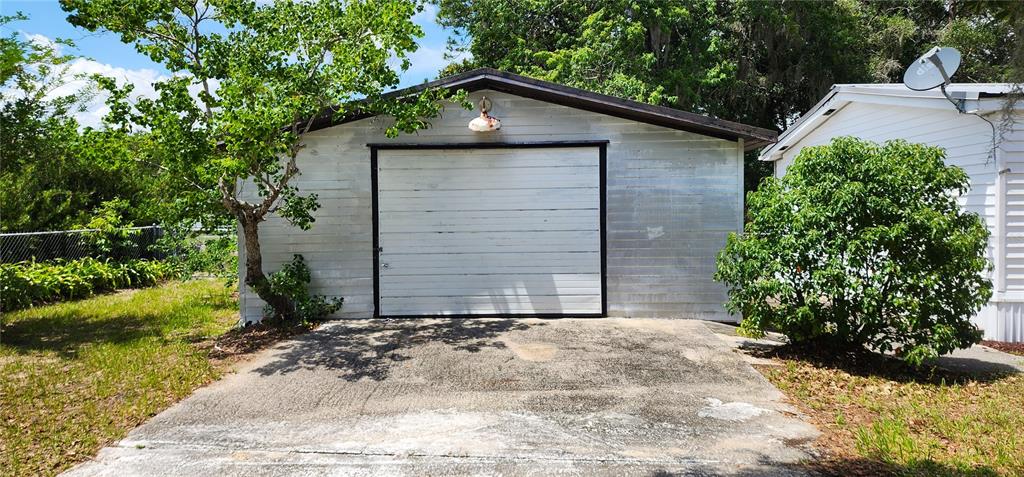 19865 Southwest 5th Place Dunnellon, FL 34431 - Photo 9 of 78 a front view of a house with a yard and garage