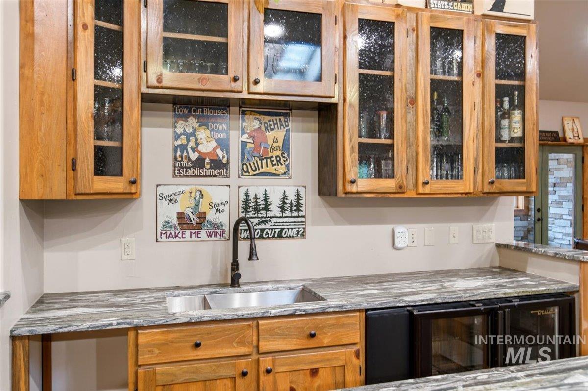 1029 Cee Way Loop McCall, ID 83638 - Photo 27 of 50 Vaulted ceiling with recessed lighting, wood-finish flooring, accent stone-faced French doors, wood trim, and a built-in cue rack