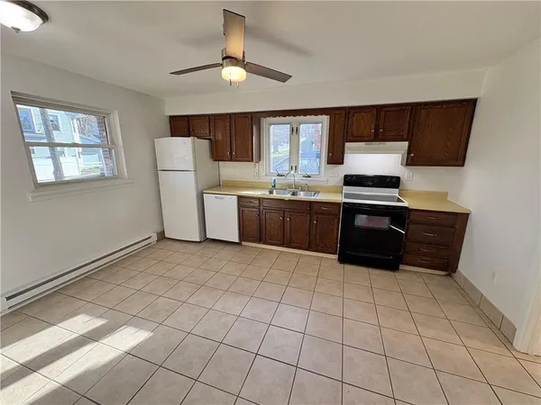 a kitchen with a stove a sink and a refrigerator