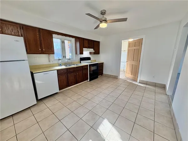 a large kitchen with a stove a refrigerator a sink dishwasher and a refrigerator