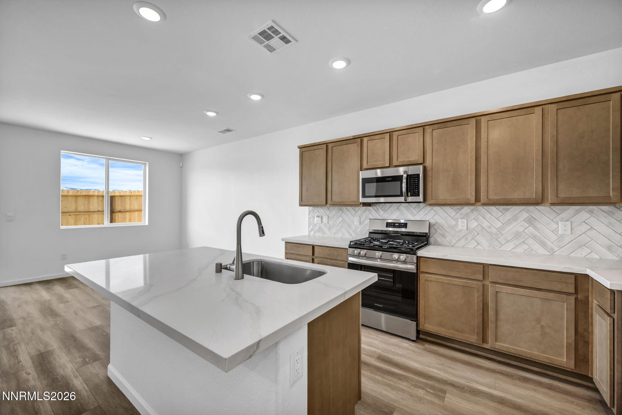 6676 Morgan Mill Road, Unit HOMESITE 14 Carson City, NV 89701 - Photo 4 of 24 a kitchen with stainless steel appliances granite countertop a sink stove and microwave