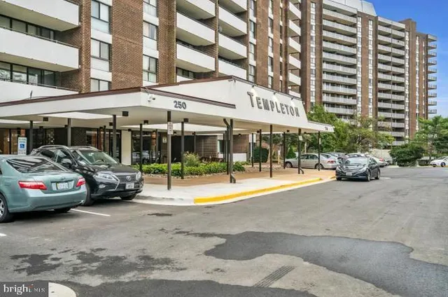 a view of a cars park in front of a building
