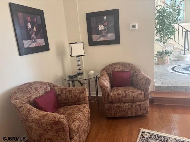 a view of a livingroom with a fireplace wooden floor and a window