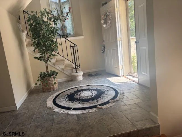 a view of a workspace with furniture and a lamp