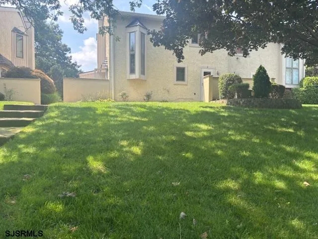 a view of house with backyard