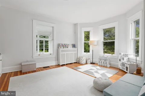 a spacious bedroom with a large bed and a window