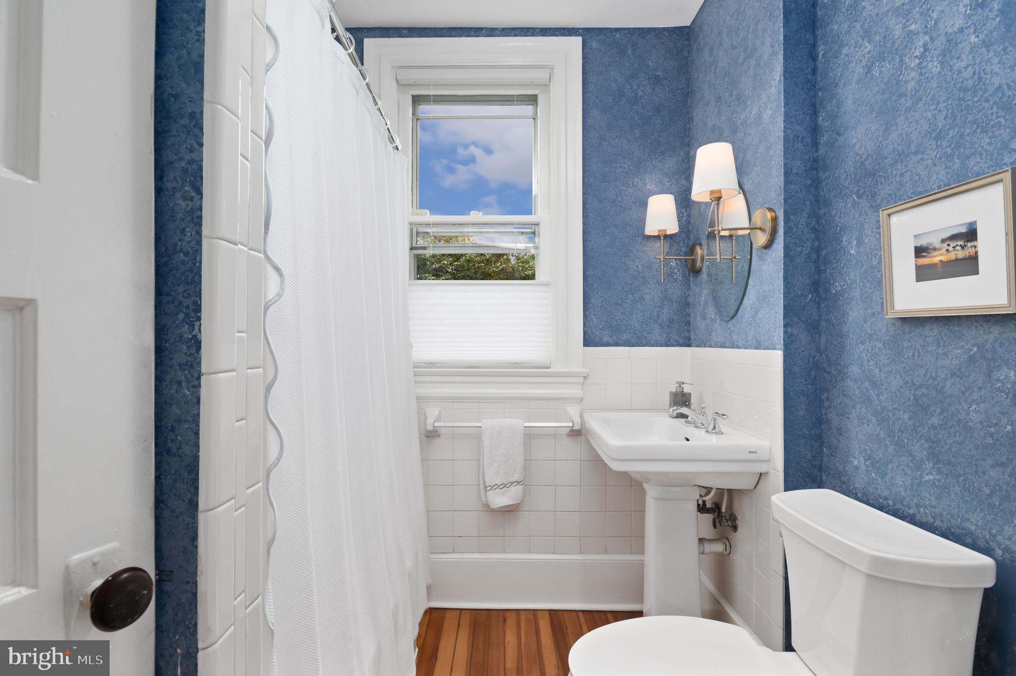6515 Brookville Road Chevy Chase, MD 20815 - Photo 14 of 33 a bathroom with a sink mirror vanity and toilet