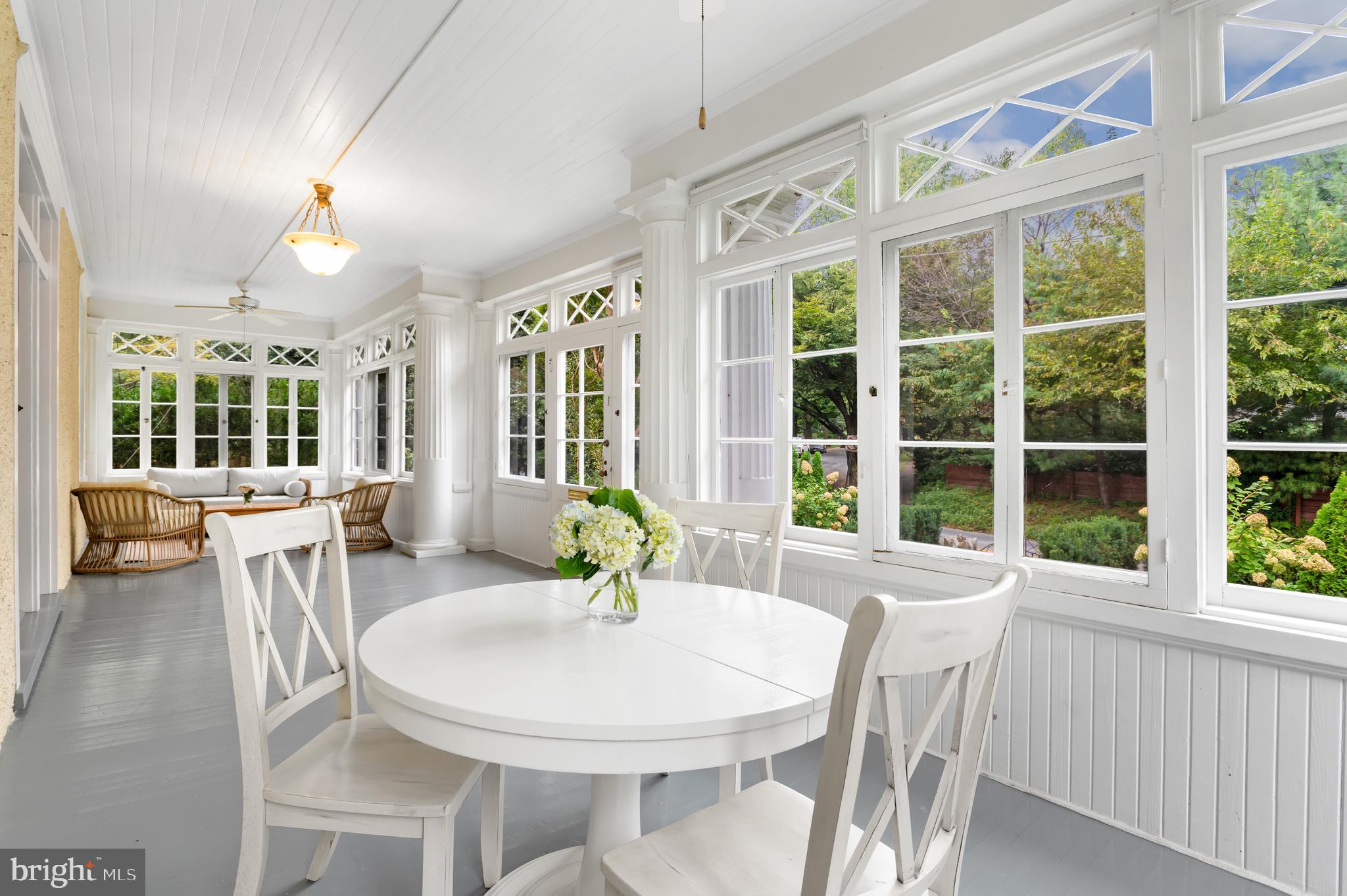 6515 Brookville Road Chevy Chase, MD 20815 - Photo 23 of 33 a view of a dining room with furniture large windows and wooden floor