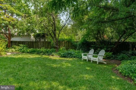 a view of a chair and table in the garden