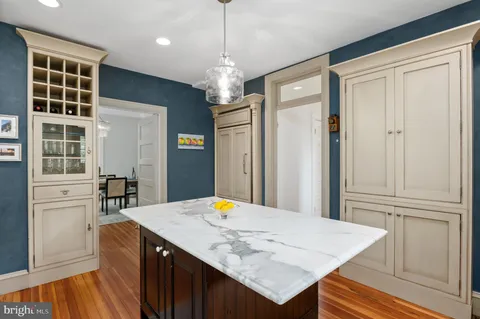 a view of kitchen island with cabinets and wooden floor