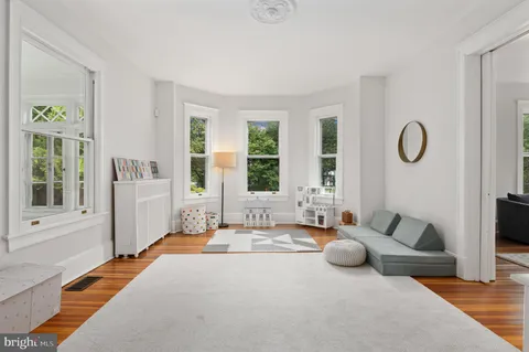 a spacious bedroom with furniture and a large window