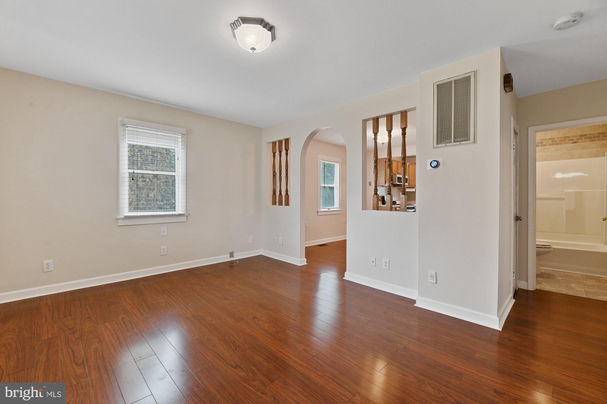 4 Plateau Road Baltimore, MD 21221 - Photo 2 of 19 an empty room with wooden floor and windows