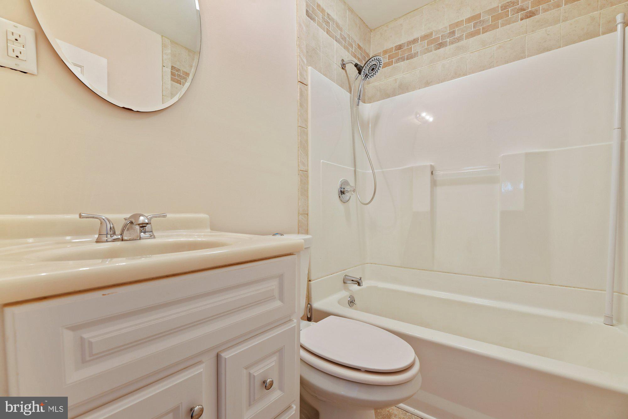 4 Plateau Road Baltimore, MD 21221 - Photo 13 of 19 a bathroom with a sink a toilet and a mirror