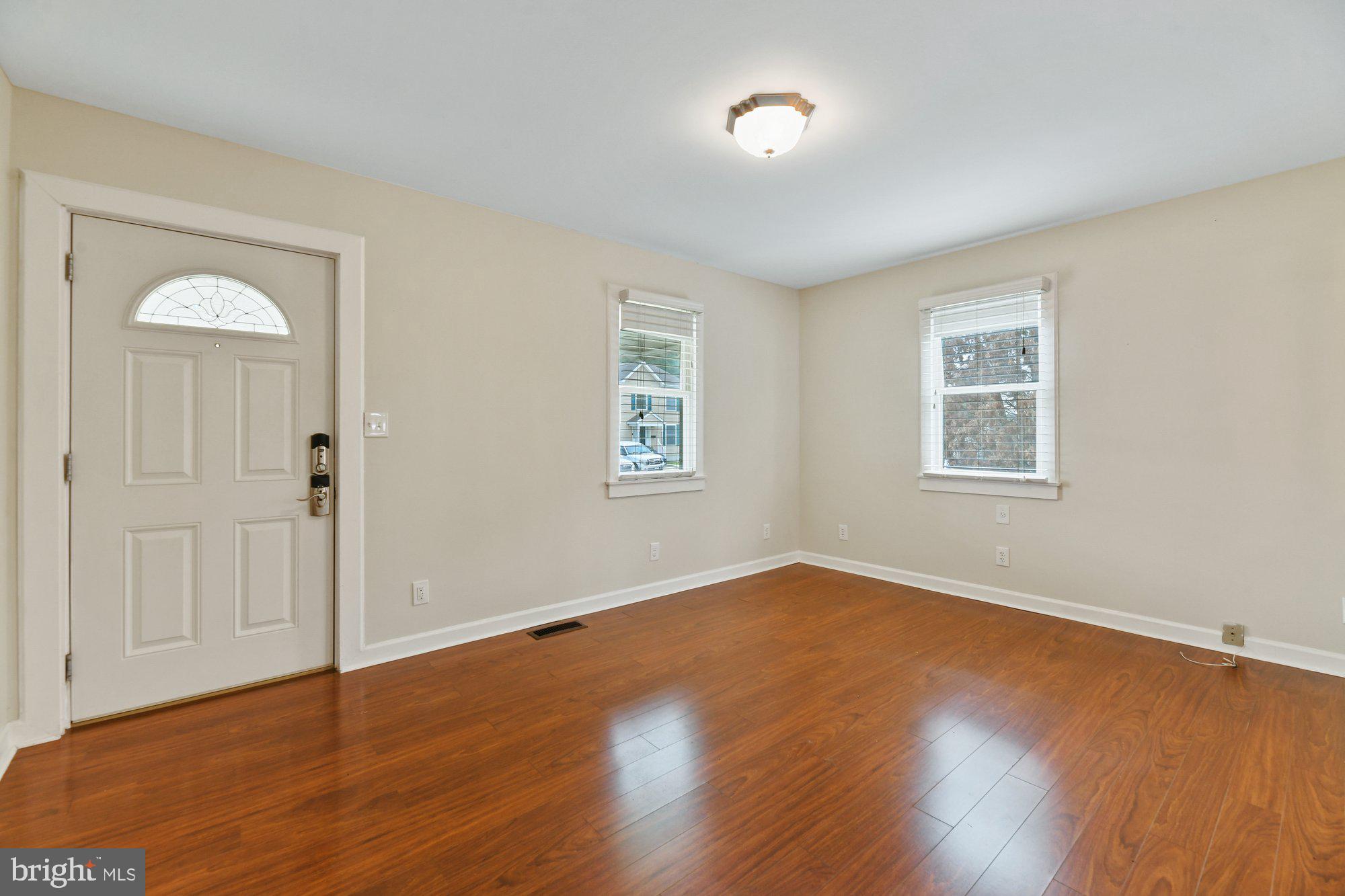 4 Plateau Road Baltimore, MD 21221 - Photo 3 of 19 an empty room with wooden floor and windows