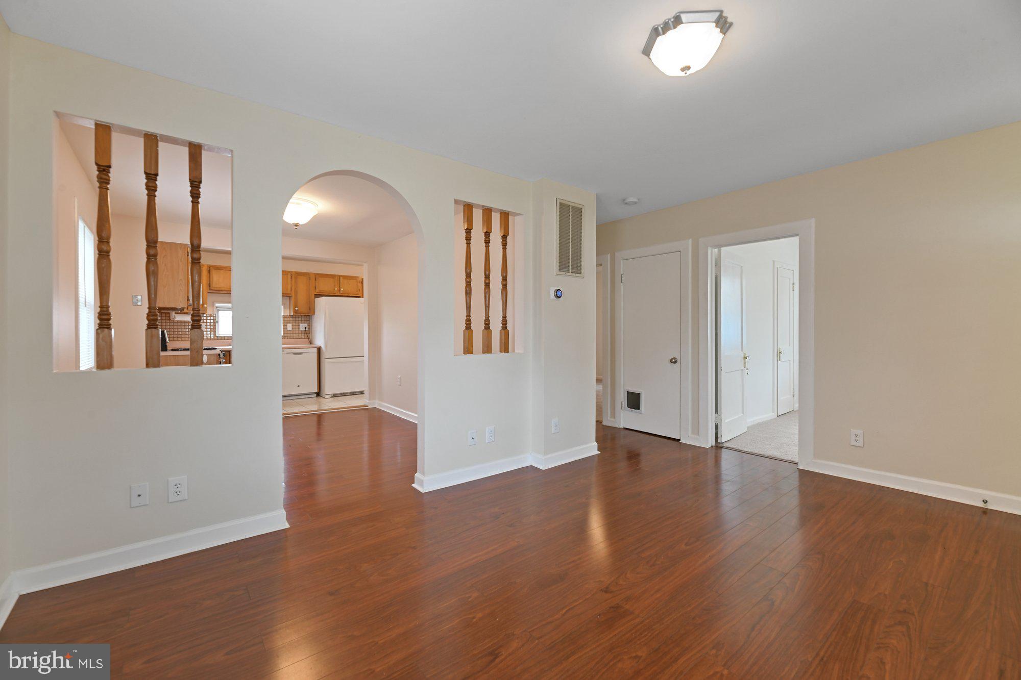 4 Plateau Road Baltimore, MD 21221 - Photo 4 of 19 an empty room with wooden floor and windows
