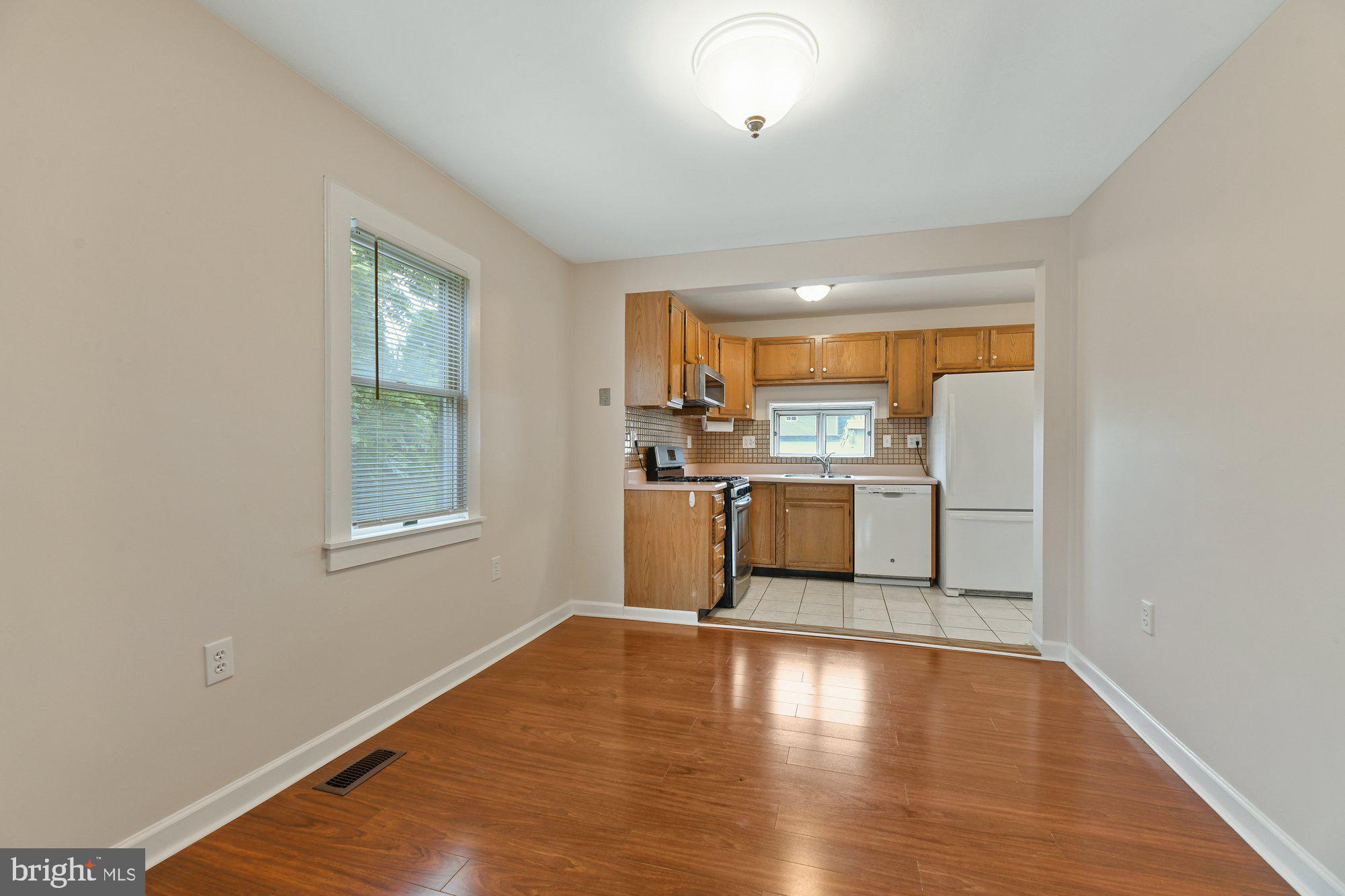 4 Plateau Road Baltimore, MD 21221 - Photo 5 of 19 a kitchen with stainless steel appliances a refrigerator and wooden floor