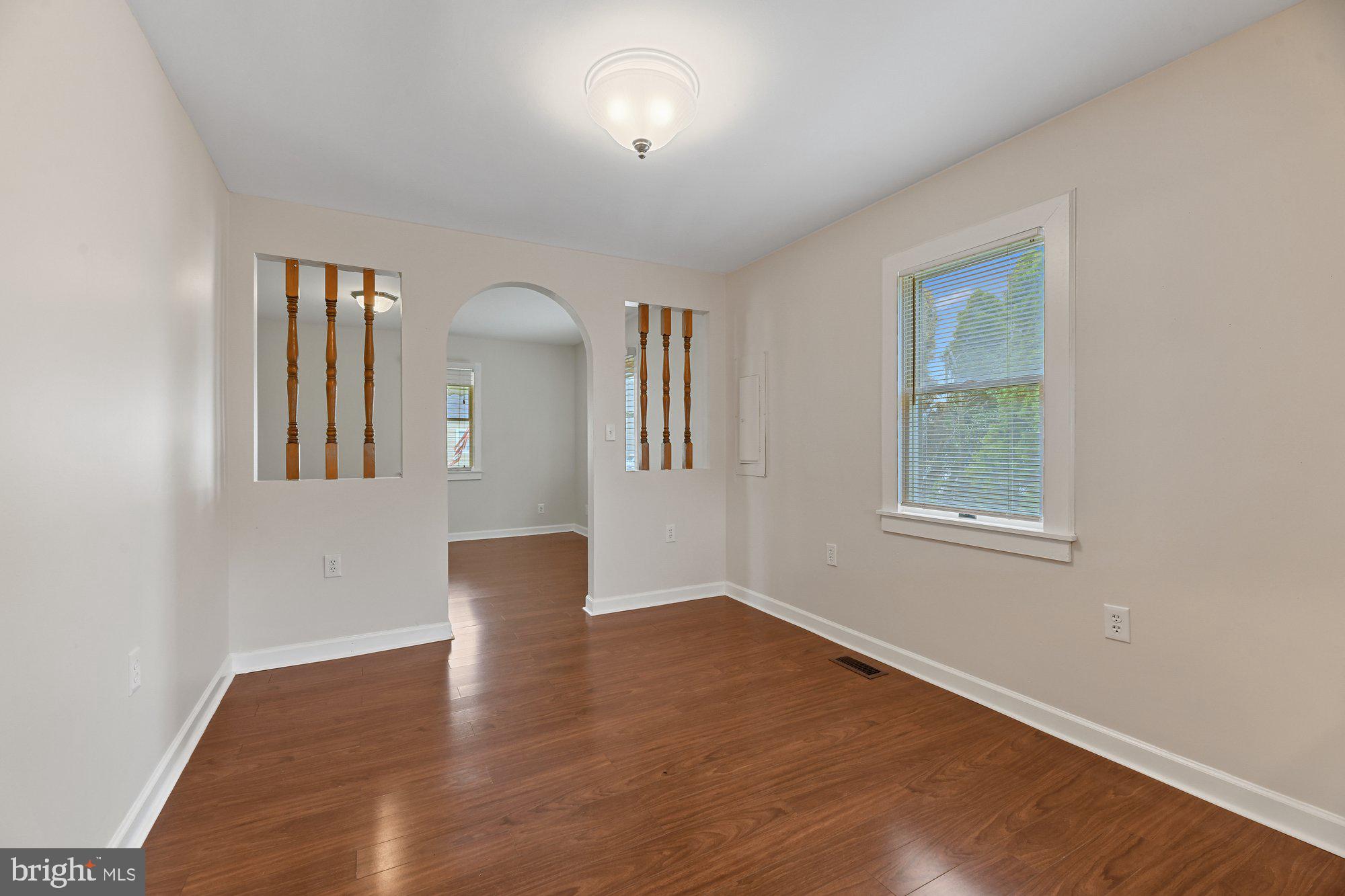 4 Plateau Road Baltimore, MD 21221 - Photo 6 of 19 a view of an empty room with wooden floor and a window