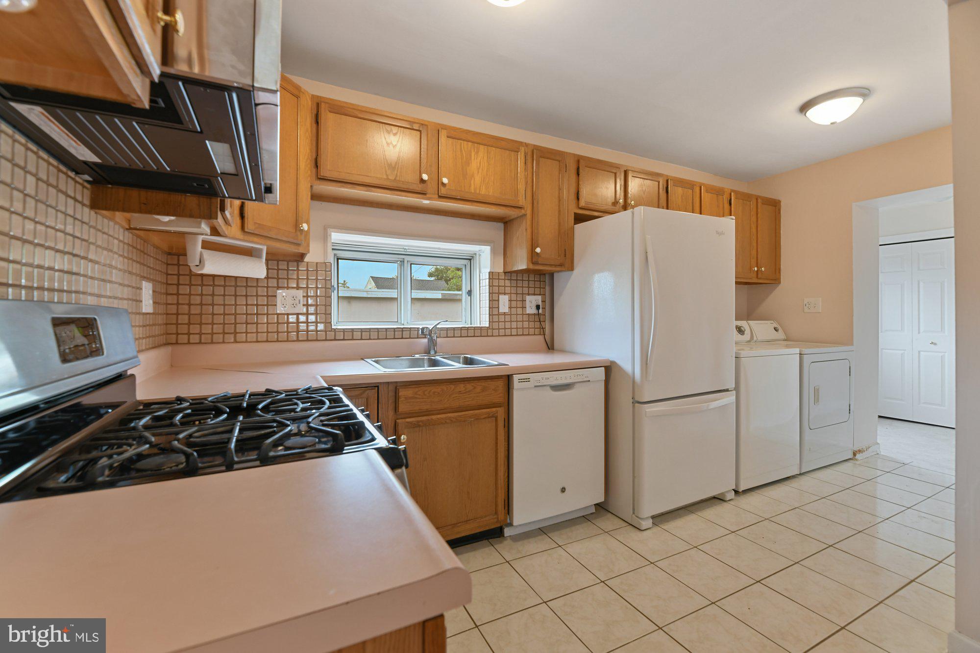 4 Plateau Road Baltimore, MD 21221 - Photo 7 of 19 a kitchen with white cabinets and white appliances