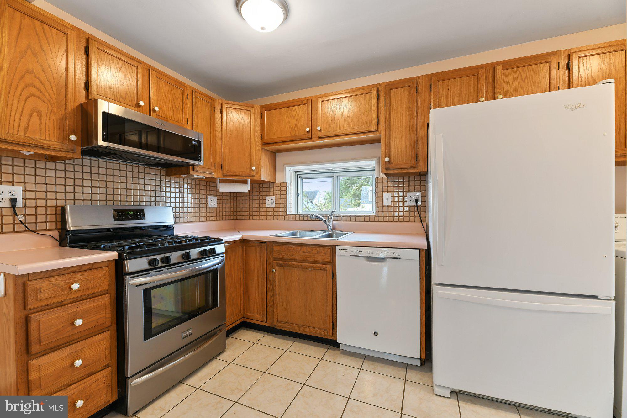 4 Plateau Road Baltimore, MD 21221 - Photo 8 of 19 a kitchen with stainless steel appliances granite countertop a refrigerator stove a sink and dishwasher